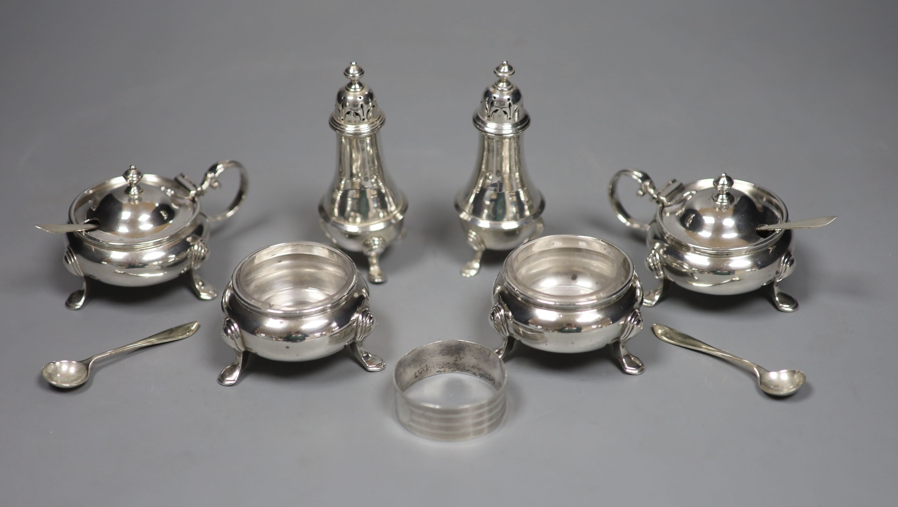 A silver six-piece condiment set, with spoons, Goldsmiths & Silversmiths Co Ltd, London, 1923/4/5 and a silver napkin ring.